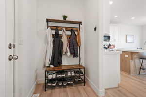 Mudroom with light wood-type flooring and recessed lighting