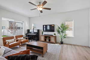 Living room with wood finished floors and a ceiling fan