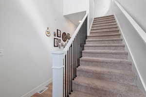 Staircase featuring wood finished floors and baseboards