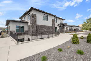 View of property exterior featuring stone siding and stucco siding