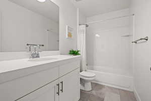 Bathroom with vanity and shower / bath combination with curtain