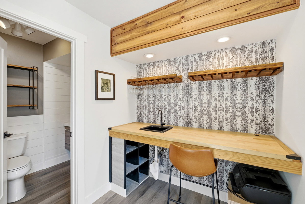 Indoor wet bar with butcher block counters, light wood-type flooring, and recessed lighting
