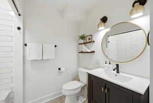 Full bath with vanity, light wood-style flooring, and a shower