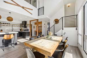 Dining space featuring light wood-style floors and a high ceiling