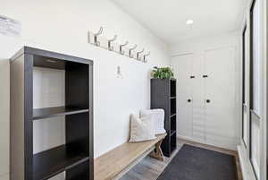 Mudroom with light wood finished floors and recessed lighting