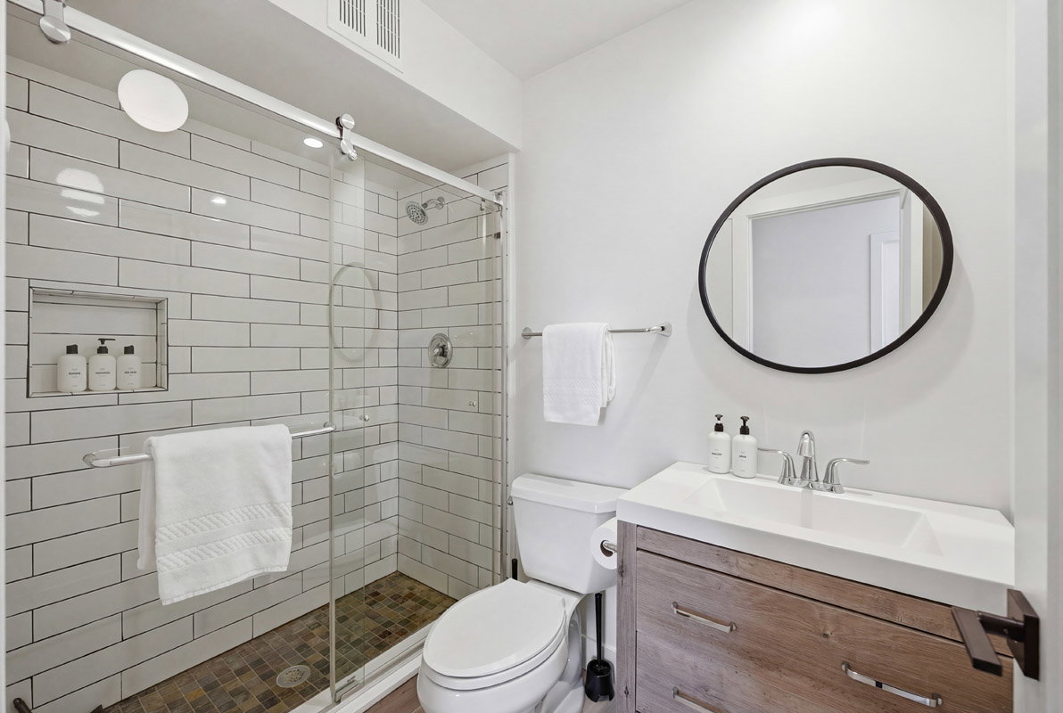 Full bath featuring vanity and a stall shower