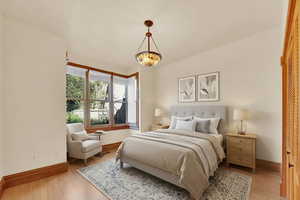 Bedroom with baseboards and light wood-style floors