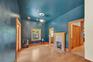 Unfurnished living room with light wood-style floors, a fireplace, and recessed lighting