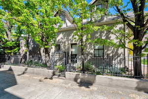 View of front of home featuring a fenced front yard, stucco siding, and a gate