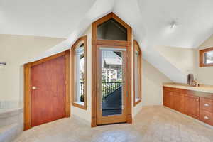 Entrance foyer featuring vaulted ceiling and plenty of natural light