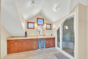 Bathroom with vanity and a shower stall