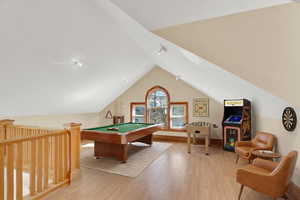 Recreation room with light wood-style floors and billiards table