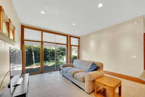 Living area featuring light tile patterned floors and recessed lighting
