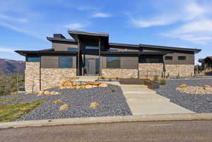 View of front facade with stone siding and a mountain view