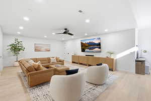 Living room featuring a ceiling fan, light wood-style flooring, and recessed lighting