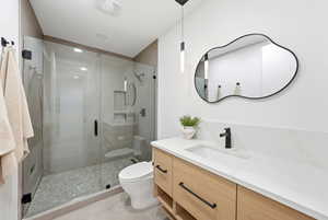 Bathroom featuring vanity, a stall shower, and light tile patterned flooring