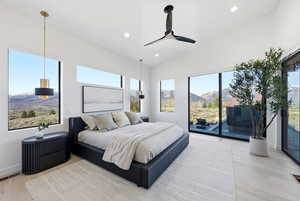 Bedroom with a mountain view, light wood-style flooring, multiple windows, recessed lighting, and a ceiling fan