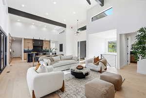 Living area featuring recessed lighting, light wood-type flooring, and a high ceiling