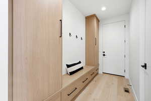 Mudroom with light wood-style flooring and recessed lighting
