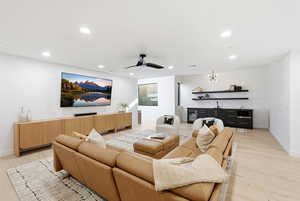 Cinema room featuring recessed lighting, a ceiling fan, light wood-type flooring, and wine cooler