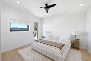Bedroom with access to exterior, light wood-style flooring, a ceiling fan, and recessed lighting