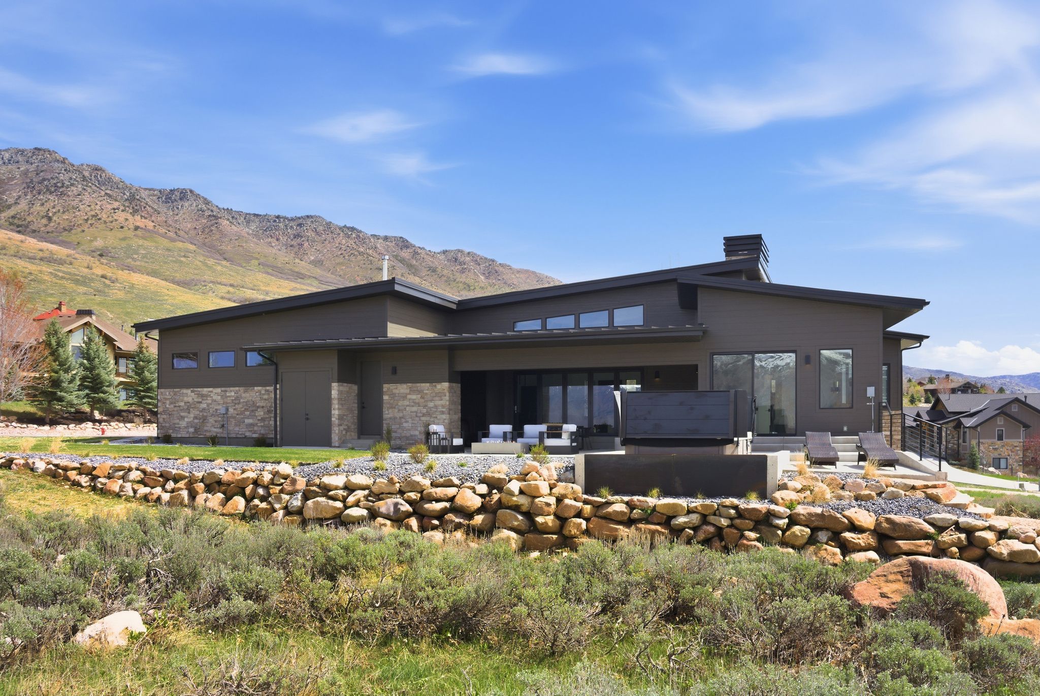 Back of property featuring a mountain view, a patio area, and a chimney