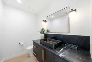 Bathroom with vanity, light wood-style flooring, and recessed lighting
