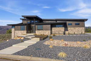 View of front of home featuring stone siding and a mountain view