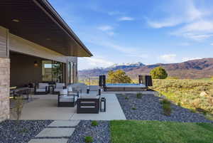 View of patio featuring a mountain view and an outdoor living space