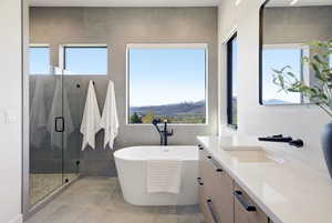 Bathroom featuring vanity, a shower stall, and a freestanding bath