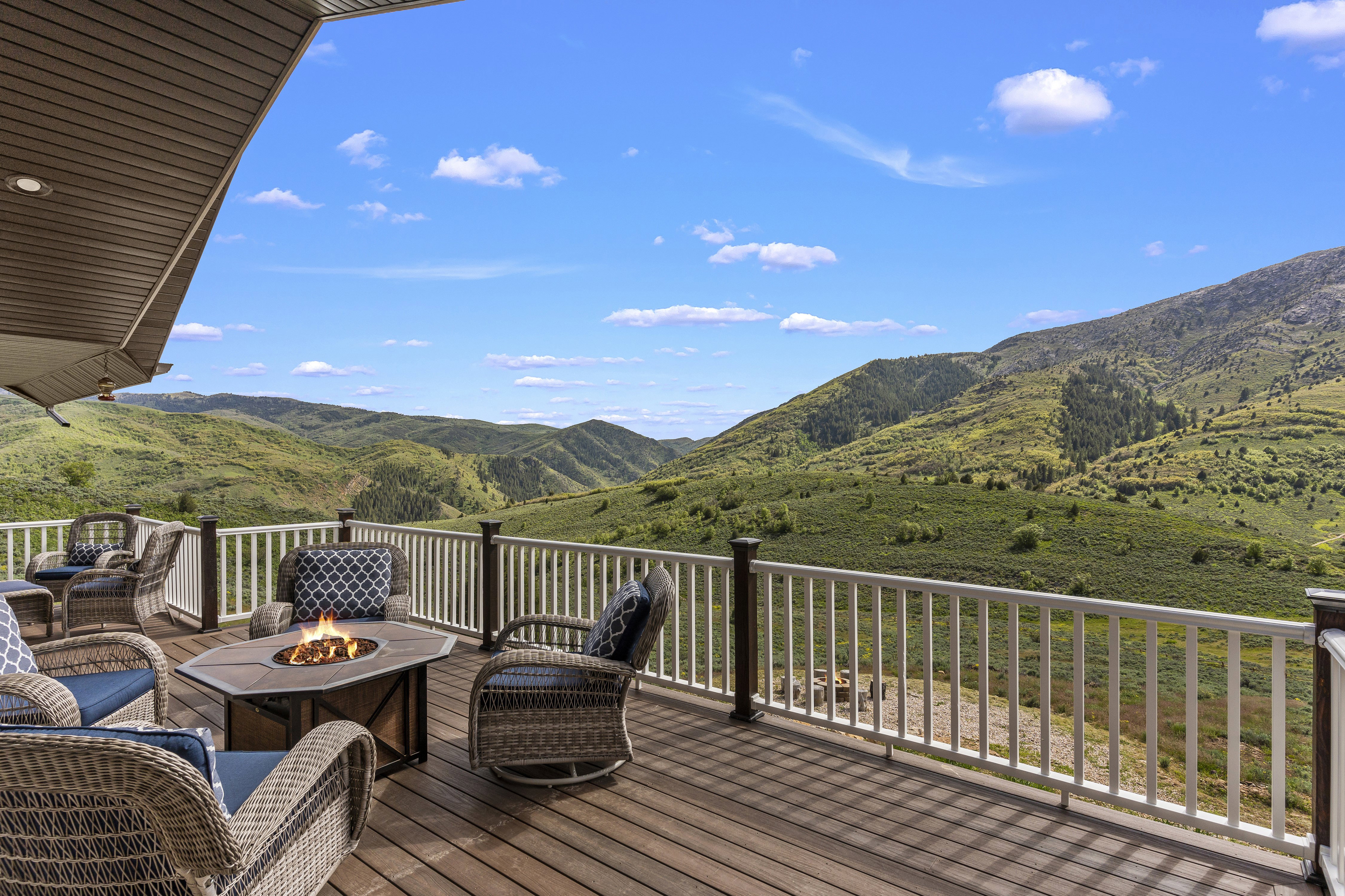 Wooden terrace featuring a fire pit and a mountain view