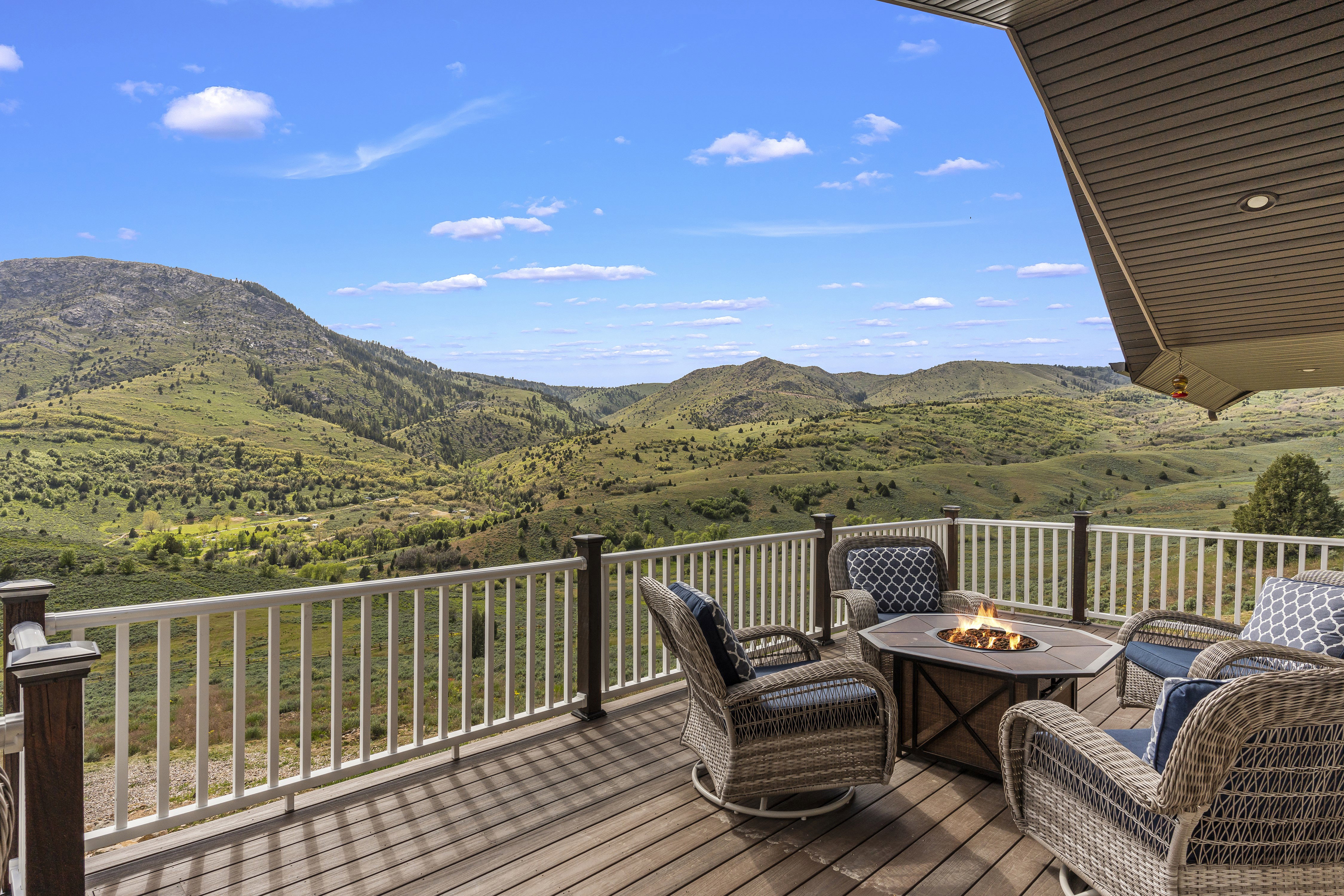 Deck with a fire pit and a mountain view