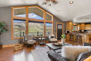 Living area featuring a mountain view, wood finished floors, a textured ceiling, and a chandelier