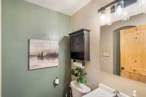 Bathroom with vanity and a textured wall