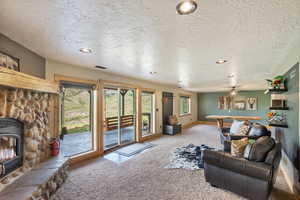 Carpeted living area featuring a textured ceiling, recessed lighting, and pool table