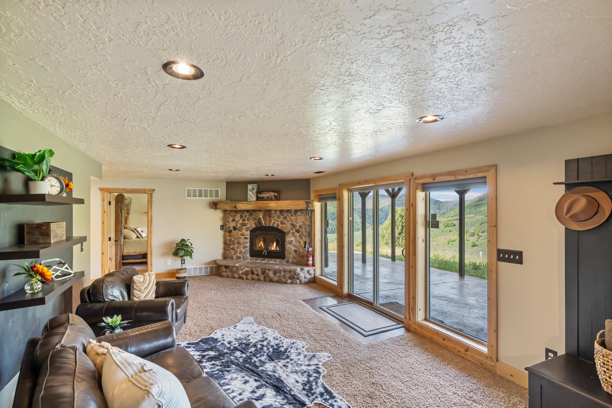 Living room featuring recessed lighting, carpet floors, a textured ceiling, and a fireplace