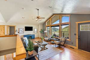 Living area featuring hardwood / wood-style flooring, a textured ceiling, and ceiling fan