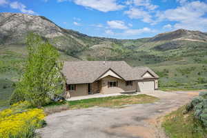 View of front of house featuring driveway, a mountain view, and an attached garage