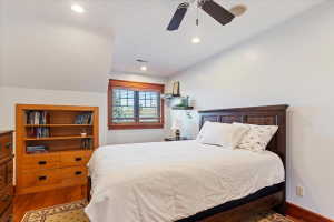 Bedroom featuring wood finished floors and ceiling fan