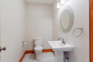 Bathroom with toilet and baseboards