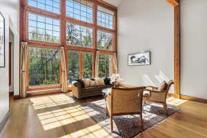 Living area featuring a high ceiling and light wood-type flooring