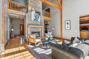 Living area with a stone fireplace and light wood-style flooring