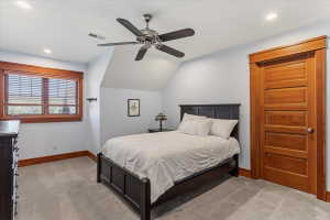 Bedroom with light carpet, a ceiling fan, recessed lighting, and lofted ceiling