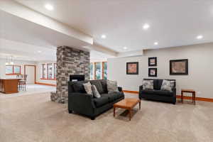 Living room featuring light carpet, a fireplace, and recessed lighting