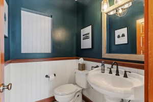 Bathroom featuring toilet and a wainscoted wall