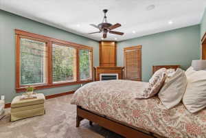 Carpeted bedroom with a ceiling fan and recessed lighting