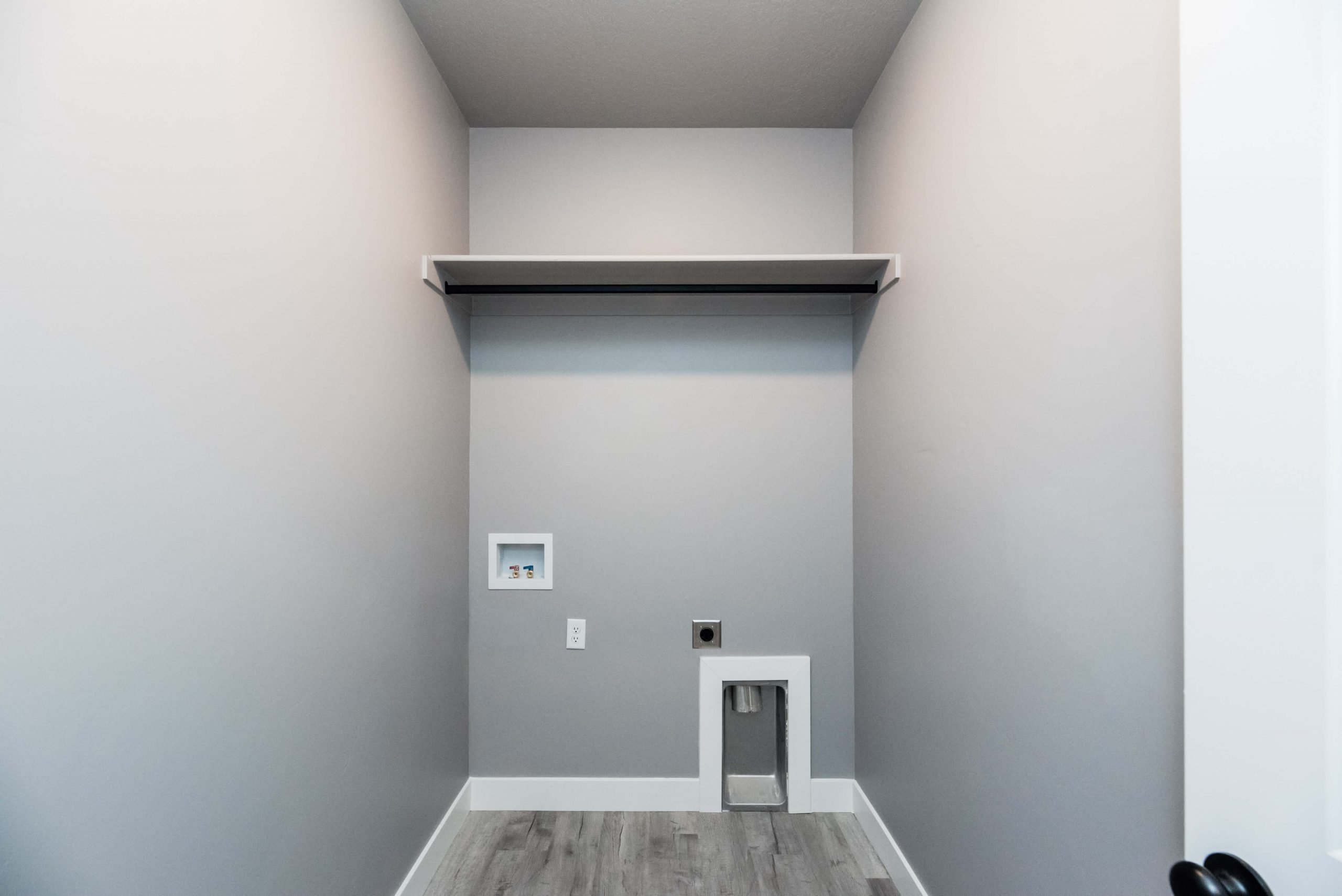 Laundry room featuring hookup for an electric dryer, washer hookup, and light wood-style floors