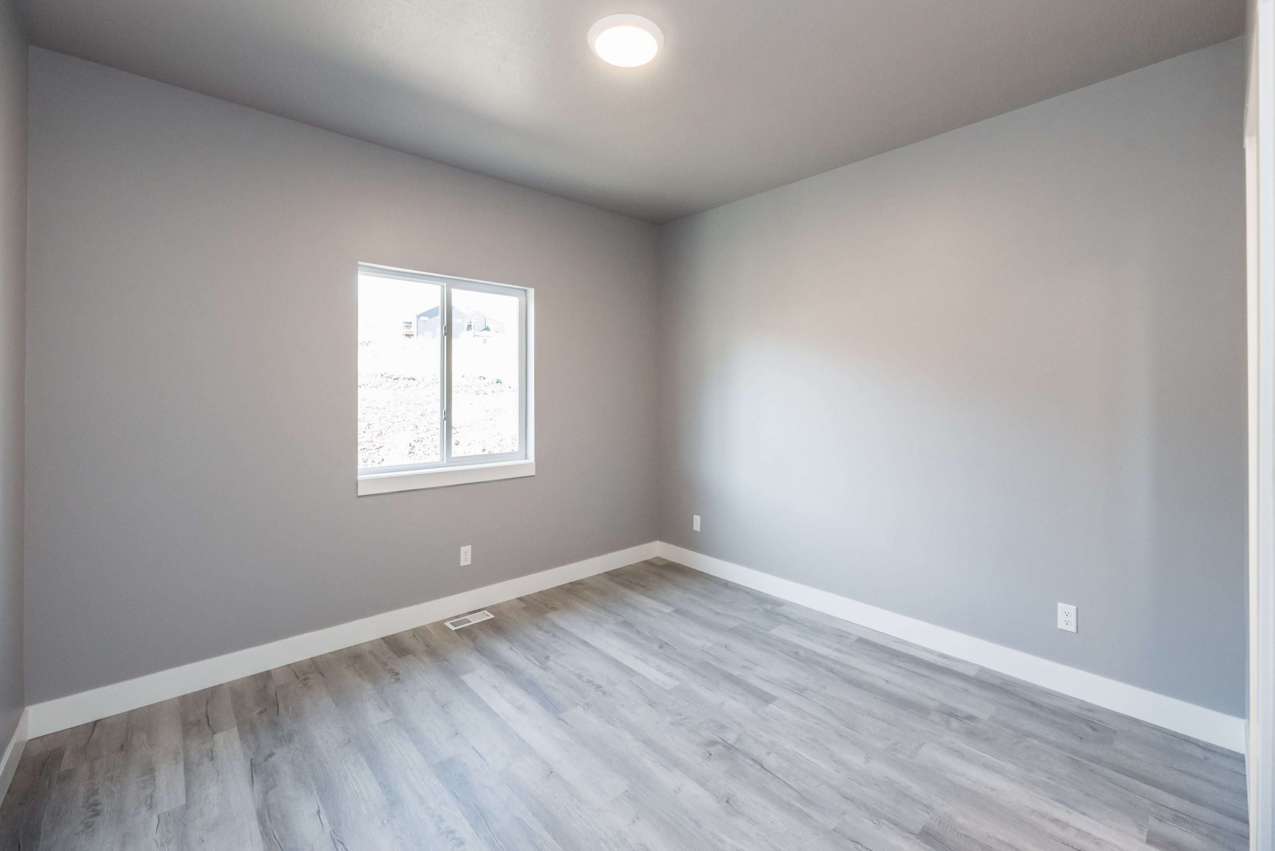 Unfurnished room featuring baseboards and light wood-type flooring