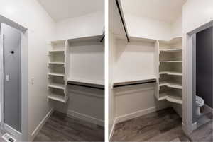 Walk in closet with dark wood-style flooring