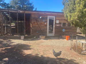Rear view of property featuring an outbuilding and exterior structure